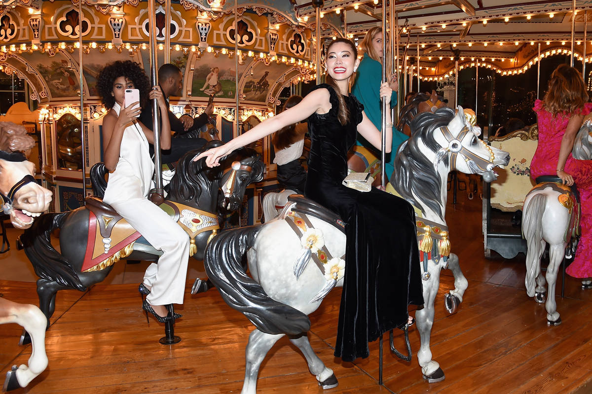 NEW YORK, NY - APRIL 21:  Imaan Hammam and Hikari Mori ride a carousel at the Tiffany & Co. 2017 Blue Book Collection Gala at ST. Ann's Warehouse on April 21, 2017 in New York City.  (Photo by Nicholas Hunt/Getty Images for Tiffany & Co.)